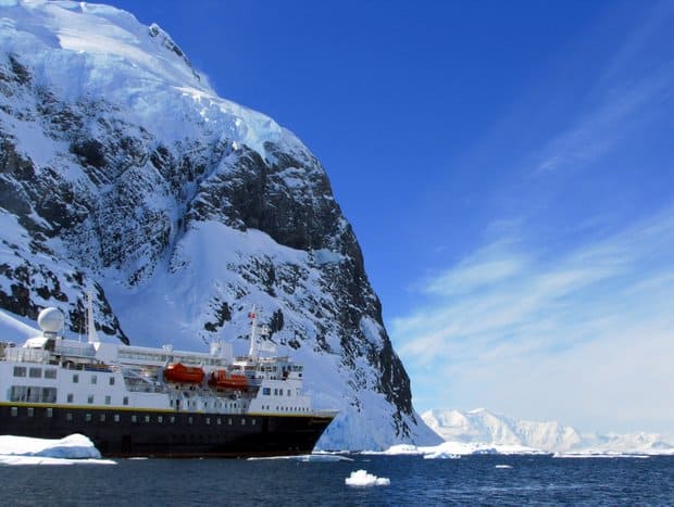 Small expedition cruise ship near land in Antarctica.