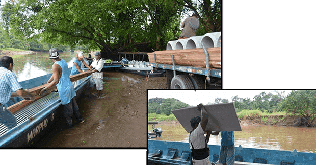 People unloading supplies off boats to renovate the Laguna de Tortuguero School in Costa Rica. 