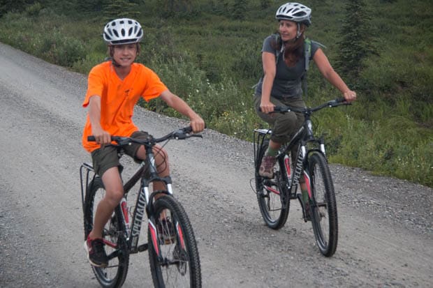 A mom and son riding bikes in Denali National Park.