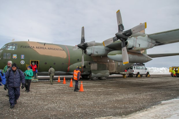 Guests boarding a Lockheed C130 Hercules aircraft in Punta Arenas Chile.