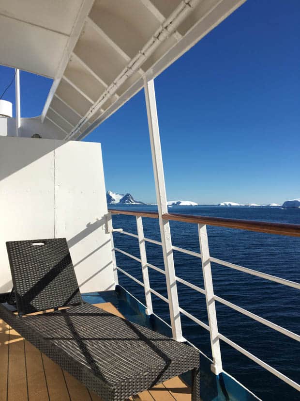 Lounge chair on a Premium Balcony suite cabin aboard a small ship in Antarctica. 