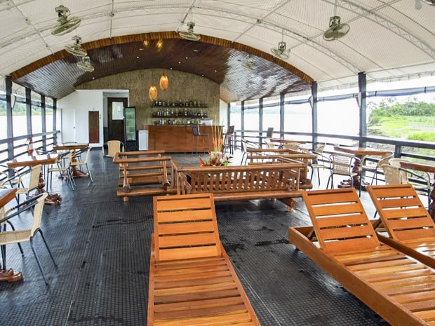 Upper deck area on the Amatista with lounge furniture and a bar.