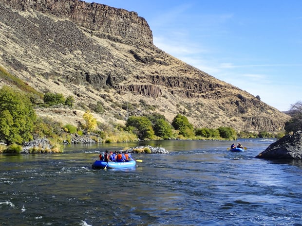Guests on a river cruise tour floating in rafts on the Deschutes River