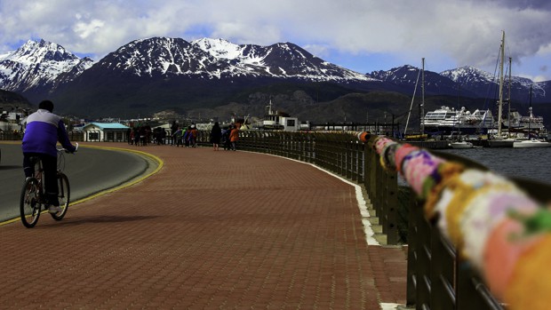 On tour in Ushuaia, Argentina along a boardwalk with the mountains in the background.