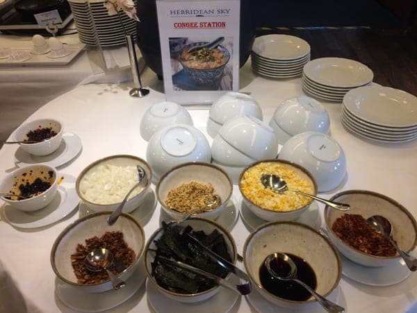breakfast station aboard hebridean sky polar expedition ship shows individual bowls of cereals, fruits, yogurt and more.