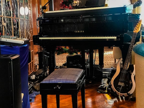 The club aboard hebridean sky polar expedition ship, a black piano is shown available for like music and entertainment