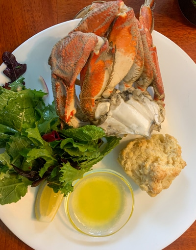 A plate of Alaskan crab dinner, fresh local cuisine, served aboard Alaska small ship catalyst.