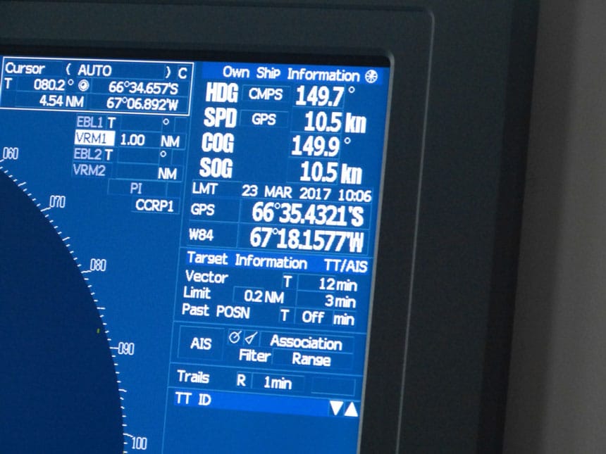 Close up of ship navigational coordinates on screen, showing 66 degrees south, or the Antarctic Circle, one of the places to visit in Antarctica.