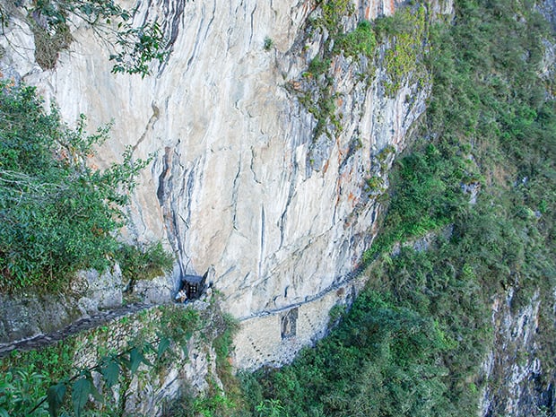 People hiking along the Inca Bridge at Machu Picchu. 