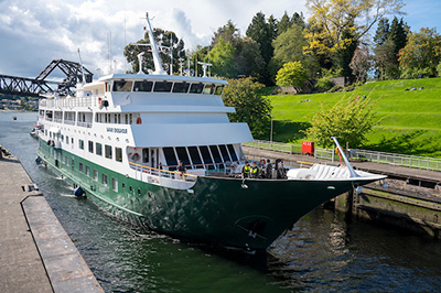 UnCruise Alaska reviews 84-guest Safari Endeavour with painted green hull and white upper decks.