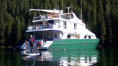 UnCruise reviews Safari Quest small ship in Alaska with painted green hull and white upper decks.