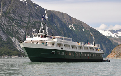 UnCruise reviews 60-guest Wilderness Adventurer in Alaska with painted green hull and white upper decks.