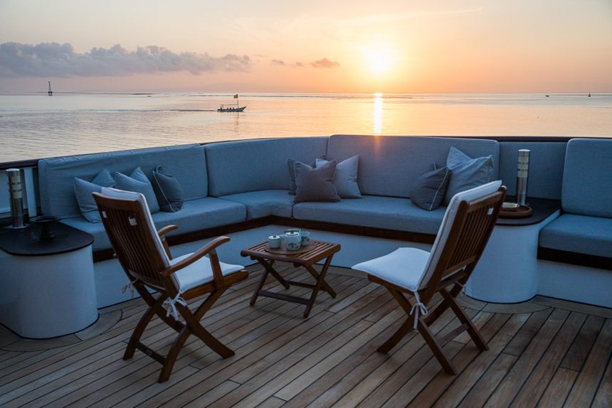 outdoor seating on small ship cruise, aqua blu on a calm night as the sunsets
