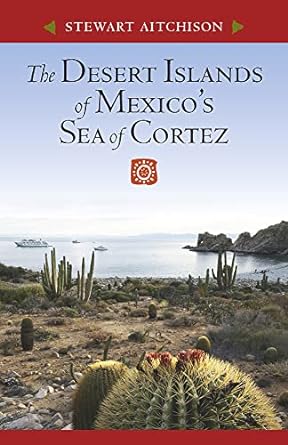 Book cover of the Desert Islands of Mexico's Sea of Cortez by Stewart Aitchison showing a desert landscape with large cactus a calm bay with two boats anchored.
