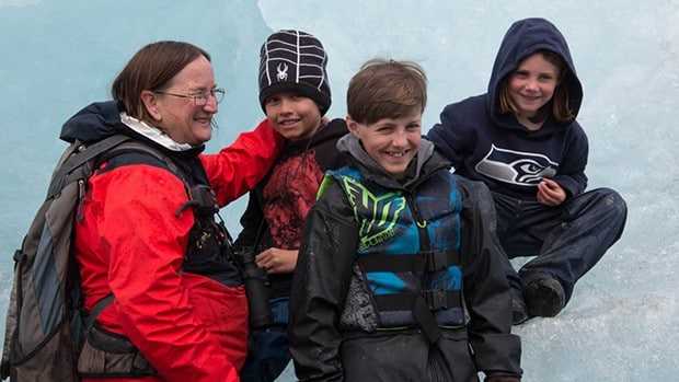Alaska family expert guide Kimber Owen leads a group of three children on an iceberg