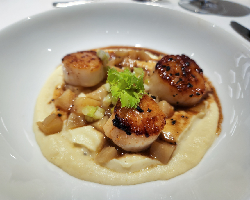 plated food from Nuna restaurant aboard Le Commandant Charcot. Scallops over mashed potatoes and vegetables.