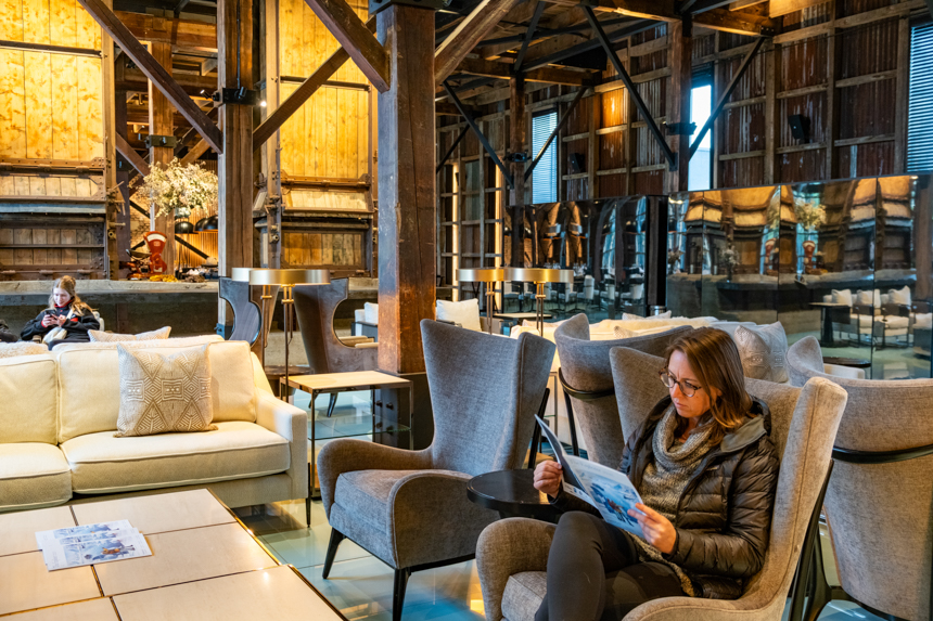 Guests reading in Antarctica21s explorers house in Punta Arenas, a restored beautiful wood building with comfortable seating