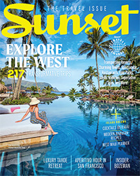 Sunset Magazine cover tropical resort with female traveler in wide brined hat lounging at pool. 