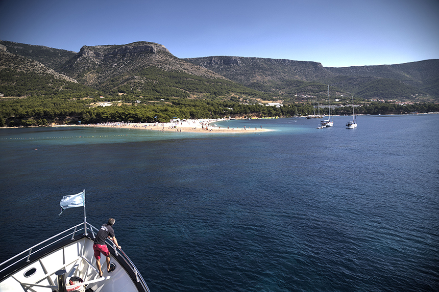 A ship sails towards Zlatni Rat Beach with is distinctive peninsula of white sand