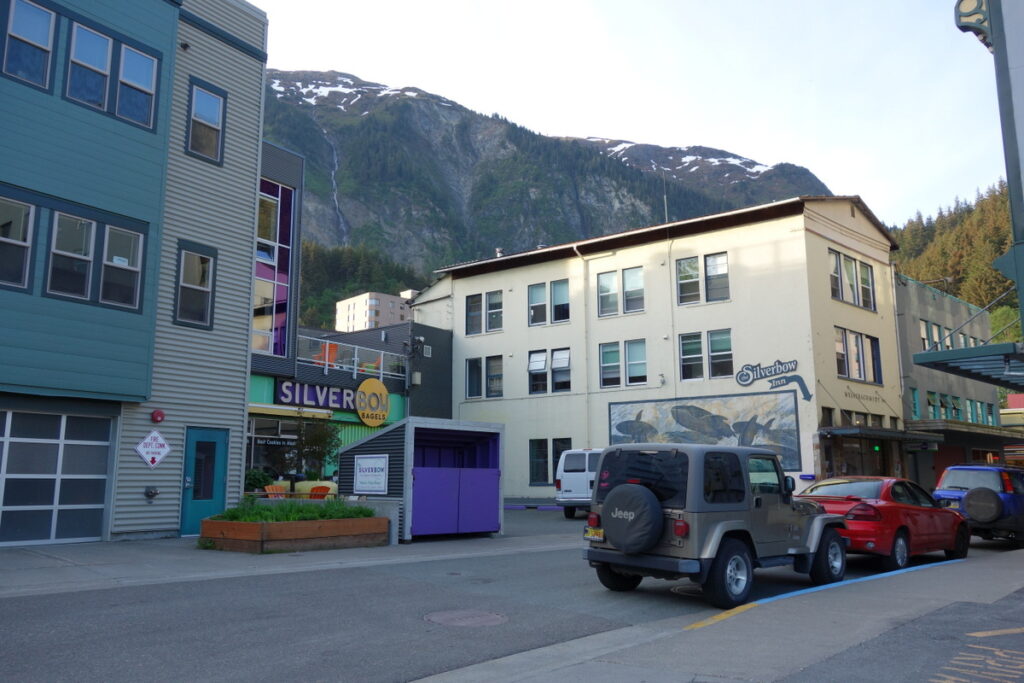Exterior of Silverbow Hotel in Juneau with a jeep and red car out front