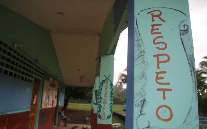 costa rica school with painted posts, one with the word respeto