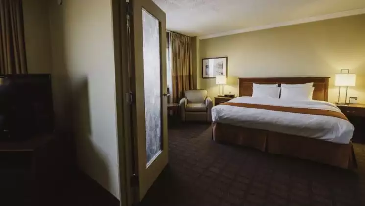 King bed with two tables and lamps in Signature Suite at Explorer Hotel in Yellowknife, Northwest Territories