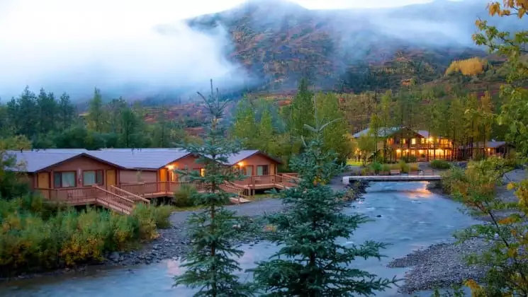 Creekside cabins in the forest at the foot of a mountain in Denali National Park at Denali Backcountry Lodge in Kantishna, Alaska