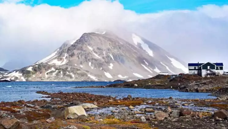 Hotel Kulusuk stands on a rocky bluff, near the water, with dramatic views of Apusiaajik Glacier and Isikajia Mountain in Greenland