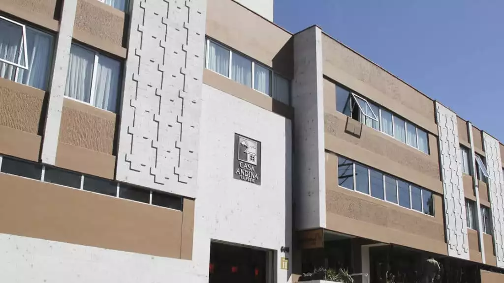 The exterior of the Casa Andina Standard Arequipa, a comfortable Peruvian hotel built with contemporary construction using white volcanic stone.