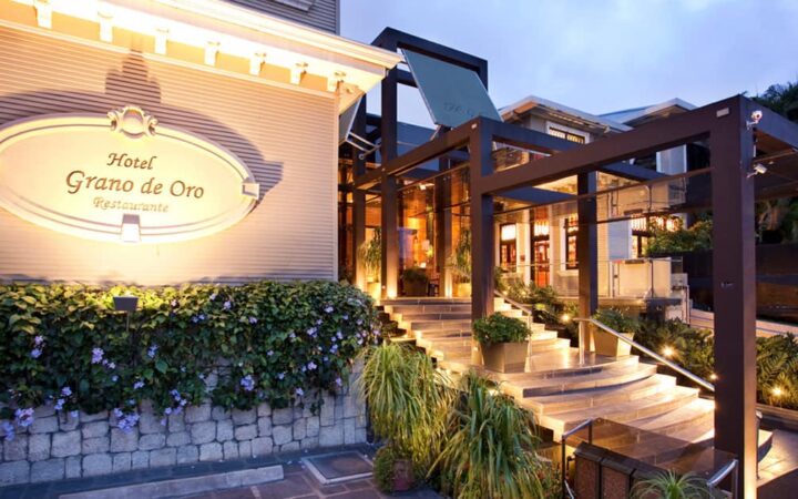 The entrance to Hotel Grano de Oro in San Jose, Costa Rica, is a renovated, elegant, Victorian mansion with steps and landscaping.