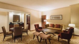 The living area with couches, tables, and chairs inside the master suite at the Marriott Hotel in Panama City.