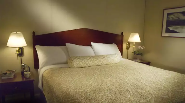 A queen bed in a room at the historic Baranof Hotel in Juneau Alaska