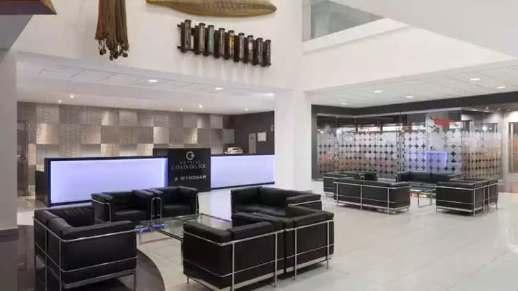 The lobby, with contemporary decor and couches for seating, at Wyndham Costa del Sol hotel, connected to the Lima International Airport