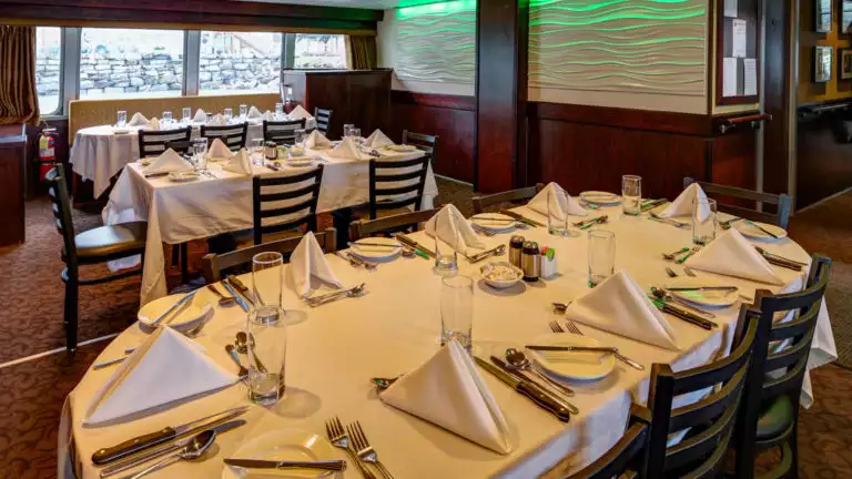 Three set tables in the dining room aboard Alaskan Dream.