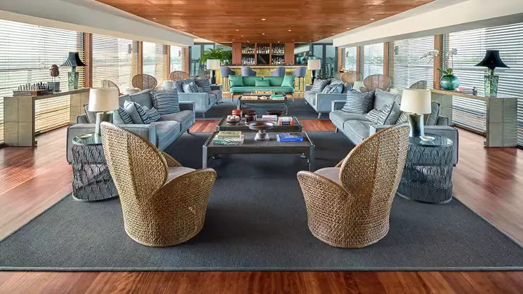 The indoor lounge offers the best comfort while cruising aboard Aqua Mekong with views of the Mekong river and countryside