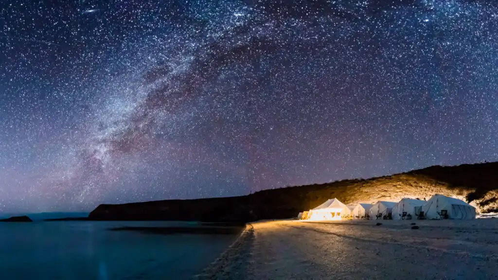Camp Cecil de la Isla is lit up at night, with a beach for stargazing at the Milky Way, on the pristine and wildly beautiful Isla Espiritu Santo, part of a National Marine Park and UNESCO World Heritage Site.