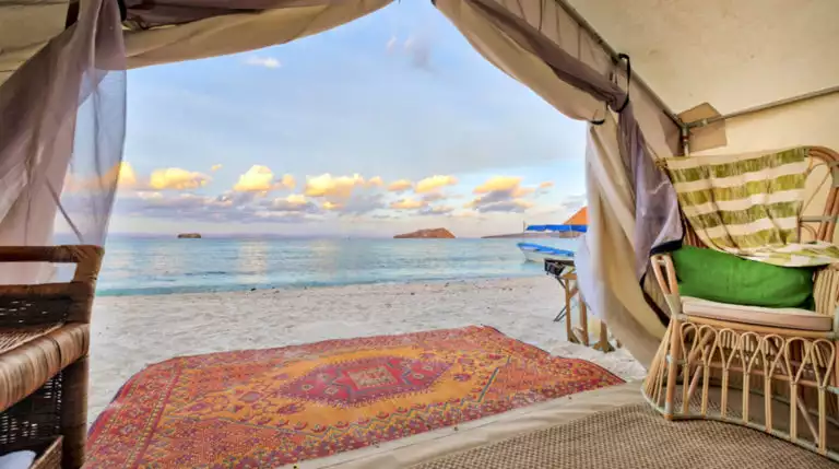 A red rug is set just outside the glamping tent on the sand, with a view of the Sea of Cortez, at Camp Cecil de la Isla, in Baja Mexico