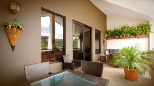 outdoor area with table, chairs and large windows with greenery in the background at hotel ladera in panama
