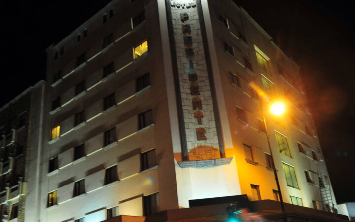 Lit up at night, the exterior of the four-star Hotel Presidente, in downtown San José, Costa Rica, a few blocks from the city's most important cultural and historical landmarks.