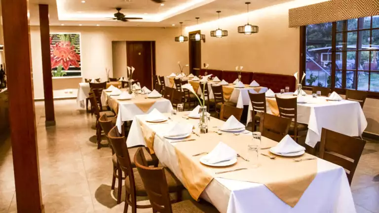 The dining room with tables set for a gourmet meal made with fresh local ingredients at the family-owned Los Brezos Hotel, near the Baru Volcano in Panama