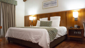 A guest room with a king-sized bed and reading lights at the family-owned Los Brezos Hotel, near the Baru Volcano in Panama