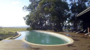The heated swimming pool is built into a raised platform overlooking the horizon on Easter Island at Posada de Mike Rapu, a luxury eco hotel in a LEED-certified building.