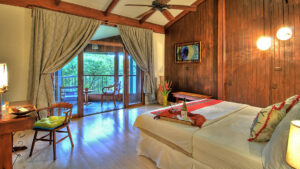 The Forest View Balcony Room with a king-sized bed, a private terrace, and views of the cloud forest at the Monteverde Lodge, a sustainable, nature retreat iin Costa Rica
