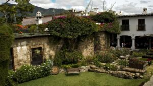 The lush garden with vines climbing the walls of the historic Posada Don Rodrigo, a renovated colonial-era hotel in Antigua