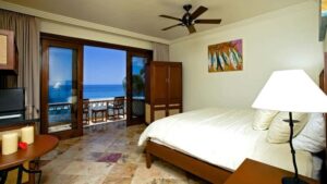 Modern, comfortable, beachfront rooms at the Cabo Surf Hotel in Baja California have comforters, marble floors, and cedar carpentry