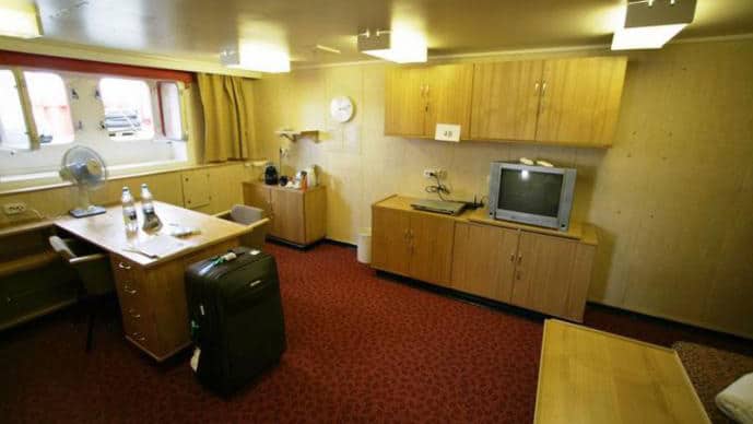 50 Years of Victory Arktika Suite with windows, desk, dresser, seating and double bed.