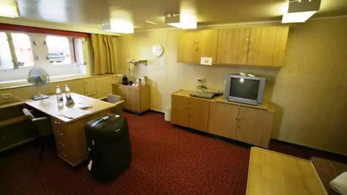 50 Years of Victory Arktika Suite with windows, desk, dresser, seating and double bed.