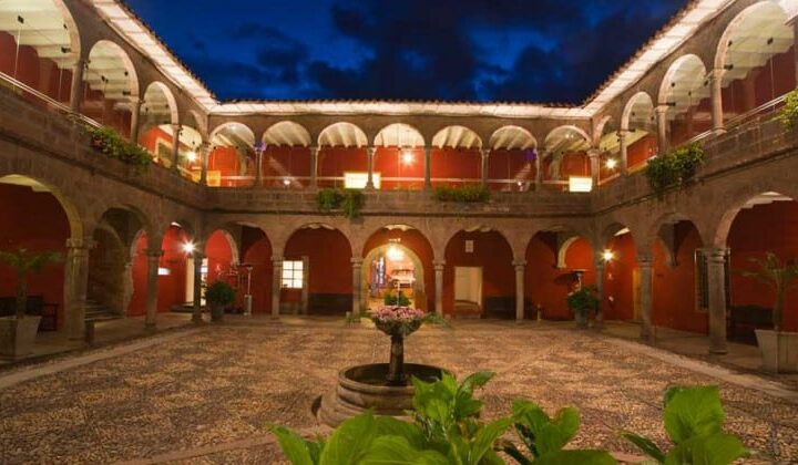 Large outdoor courtyard with small fountain centerpiece and several plants at Costa del Sol Ramada Cusco in Peru