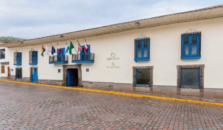 Exterior of Costa del Sol Ramada Cusco in Peru with international flags hanging above main entrance