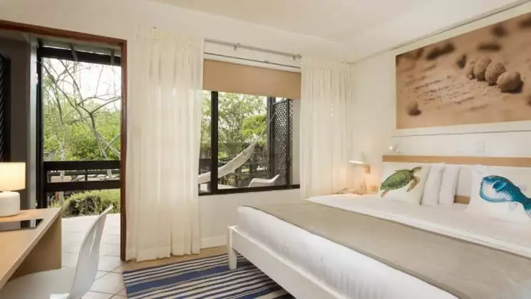 Room with king bed at Finch Bay Eco Hotel